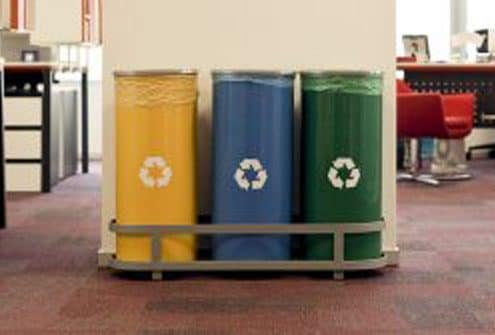 yellow, blue, and green recycle bins set up in an office