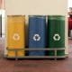 yellow, blue, and green recycle bins set up in an office