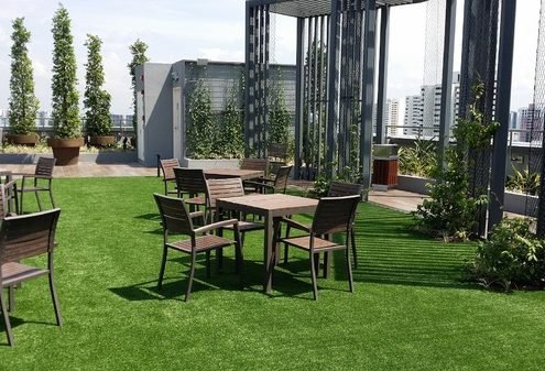 View of tables and chairs on a rooftop patio.