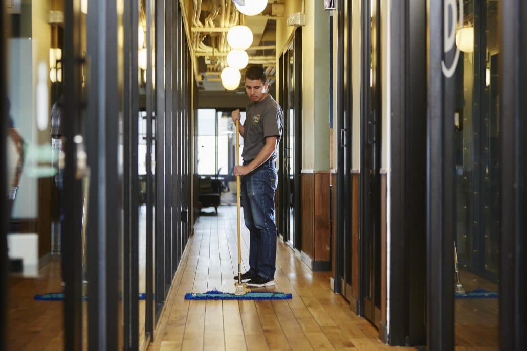 Man cleaning hardwood floors.