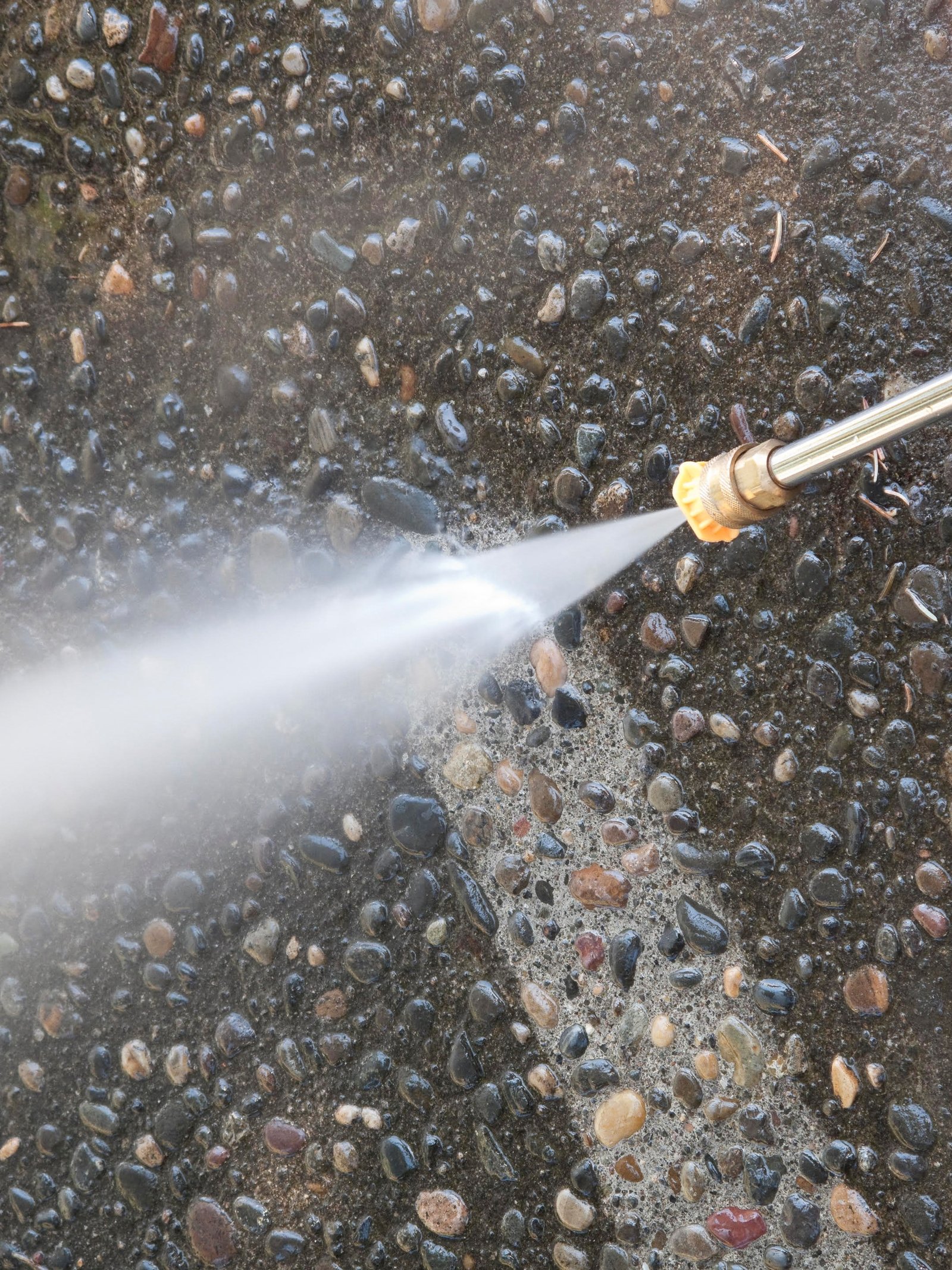 pressure washing vertical rotated Pressure washer cleaning a driveway.