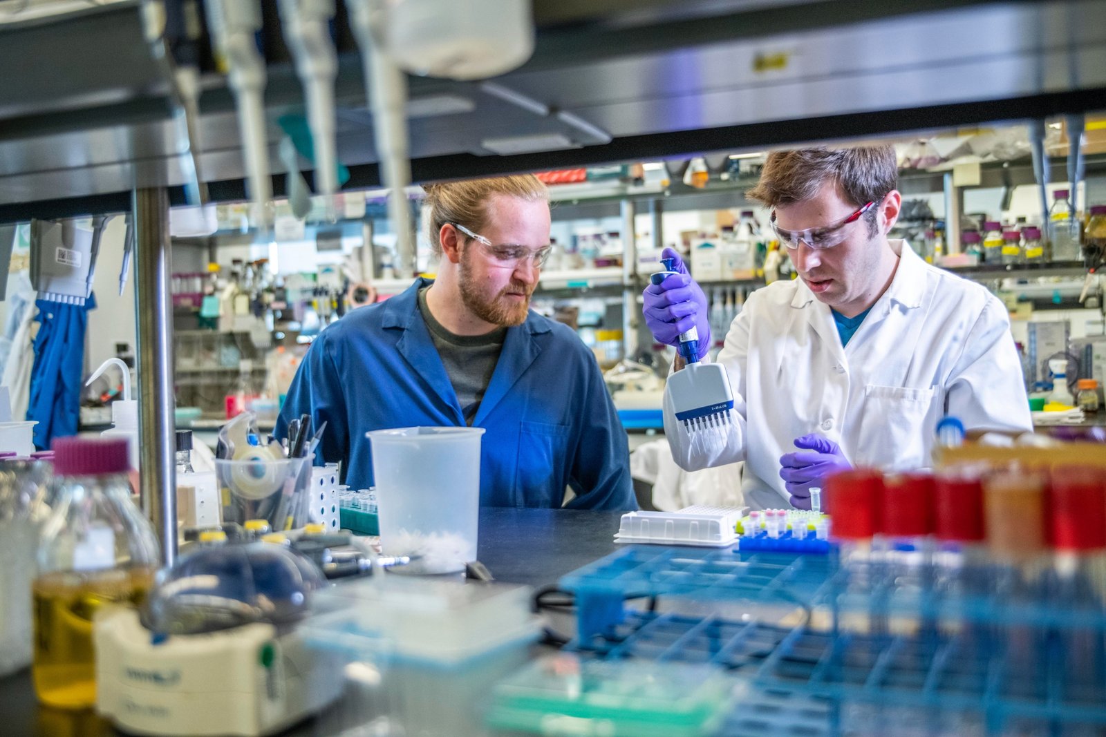 Two men wearing lab coats in a lab.
