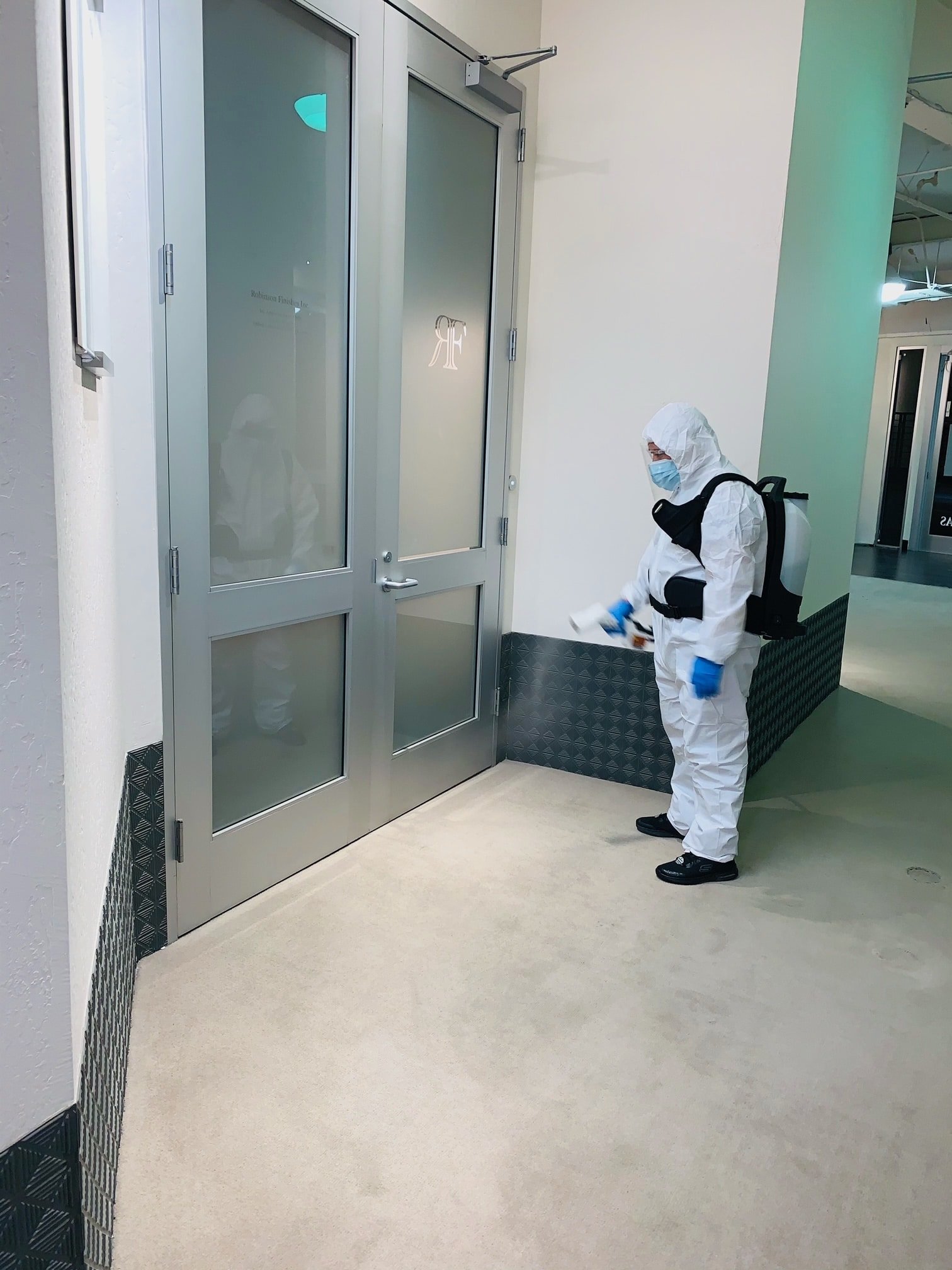 Commercial Disinfecting Service A professional disinfecting a doorway